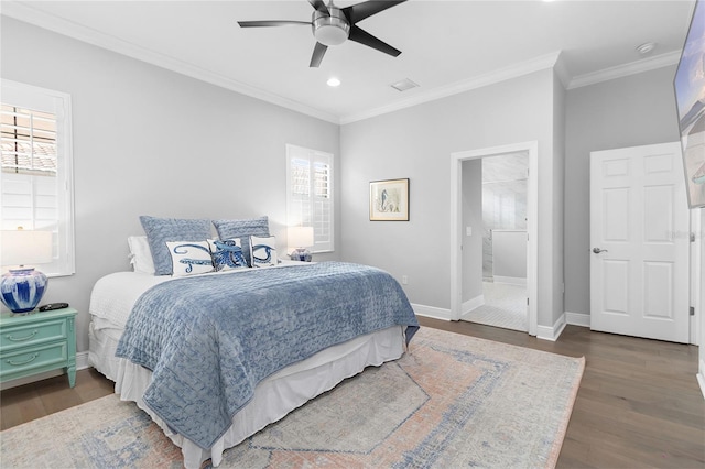 bedroom with multiple windows, ensuite bathroom, dark wood-type flooring, and ceiling fan