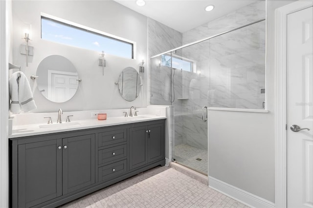 bathroom with a shower with door, vanity, and tile patterned flooring