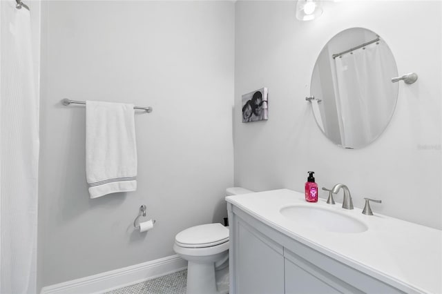 bathroom with vanity, toilet, and tile patterned flooring