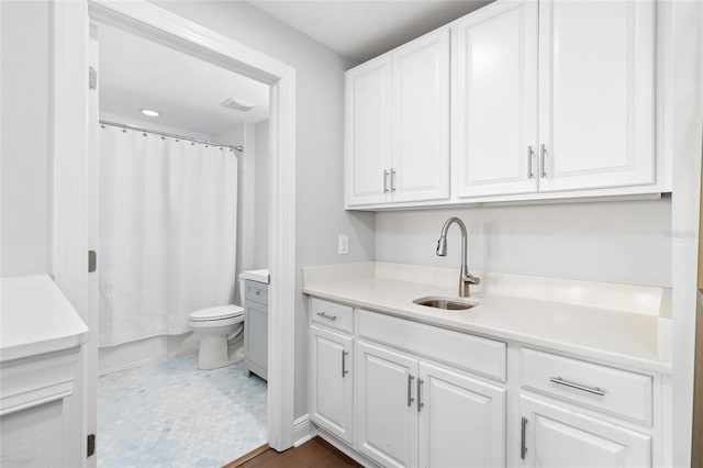 bathroom featuring vanity, toilet, curtained shower, and tile patterned flooring