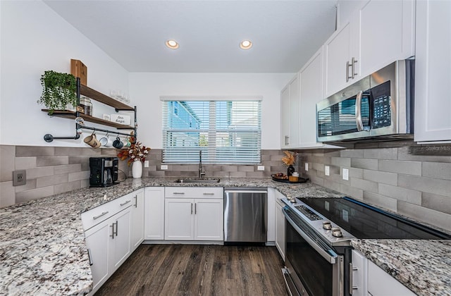 kitchen featuring sink, white cabinets, dark wood-type flooring, and stainless steel appliances