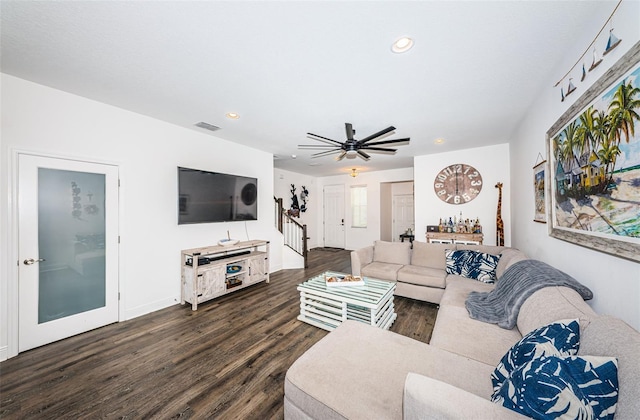 living room with ceiling fan and dark hardwood / wood-style floors