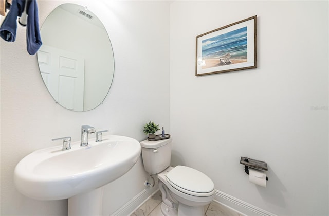 bathroom featuring toilet and sink