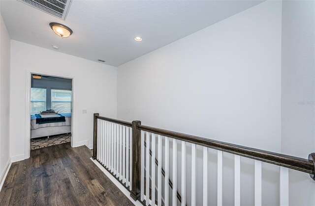 corridor featuring dark hardwood / wood-style floors