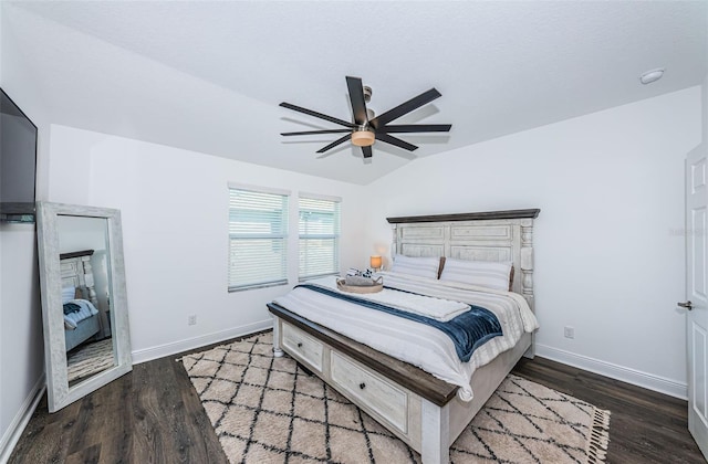 bedroom with ceiling fan, vaulted ceiling, and hardwood / wood-style floors