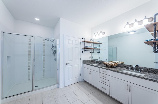 bathroom featuring vanity and an enclosed shower