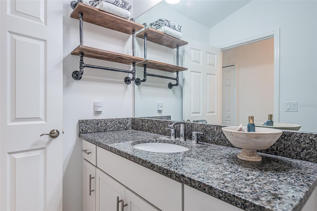 bathroom with vanity and vaulted ceiling