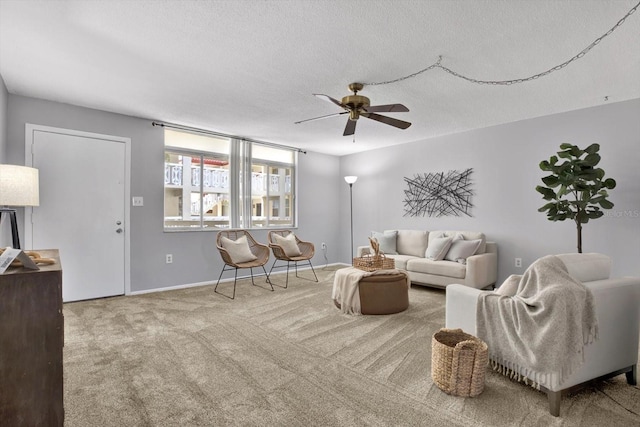 living room featuring light carpet, a textured ceiling, and ceiling fan