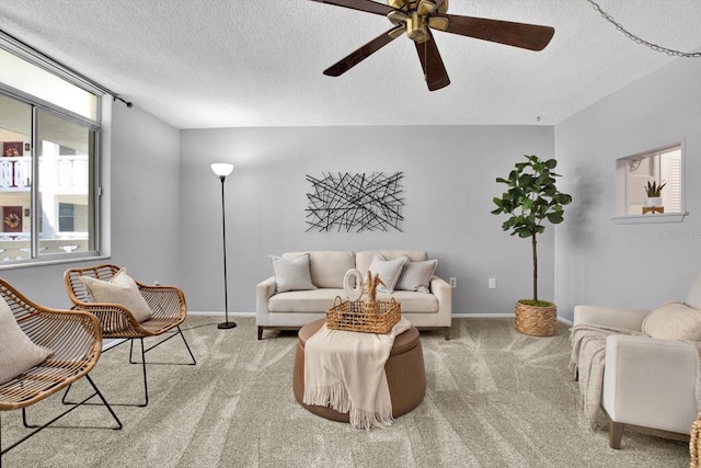 living room featuring light carpet, a textured ceiling, and ceiling fan