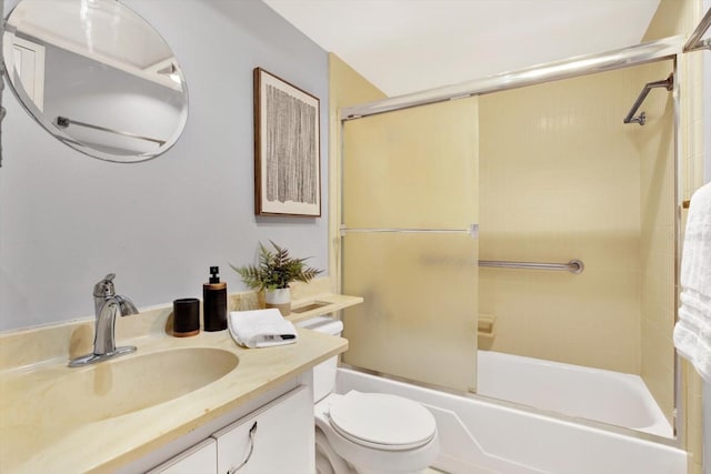 full bathroom featuring vanity, shower / bath combination with glass door, and toilet