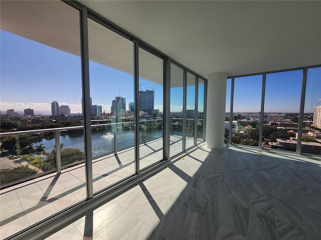 bedroom with expansive windows and a water view