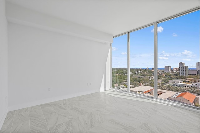 empty room featuring a wall of windows