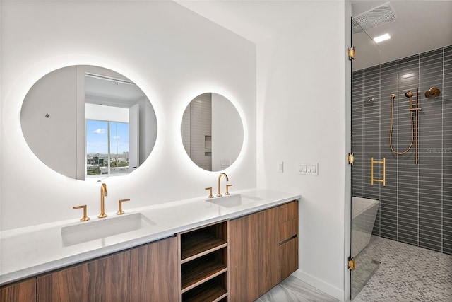 bathroom with vanity and a shower with door