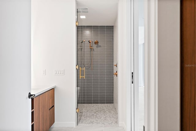 bathroom featuring vanity, tile patterned floors, and walk in shower