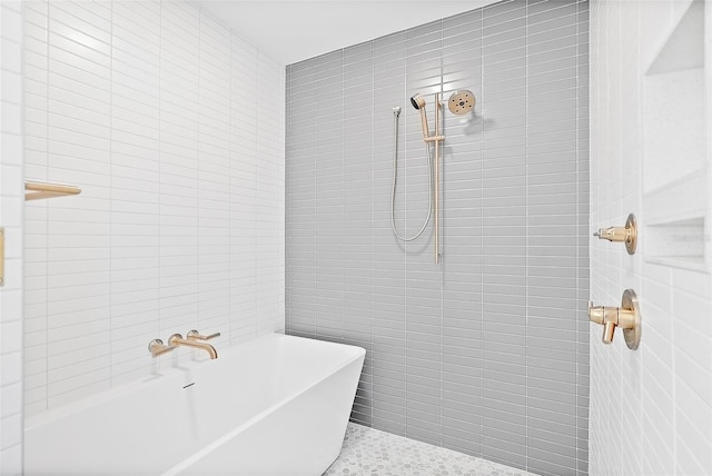 bathroom featuring shower with separate bathtub