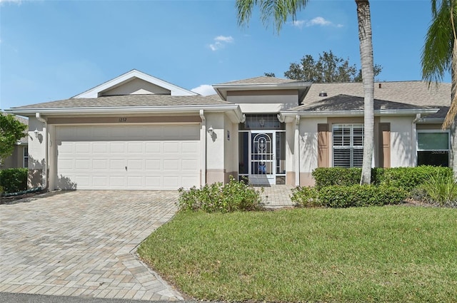 ranch-style house featuring a garage and a front yard