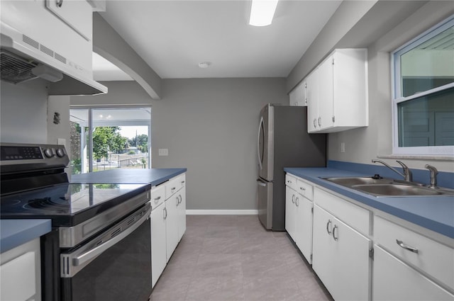 kitchen featuring stainless steel appliances, extractor fan, white cabinets, and sink