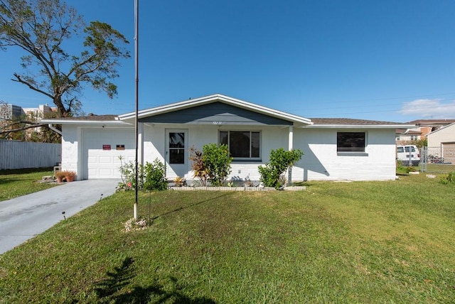 single story home featuring a front yard and a garage