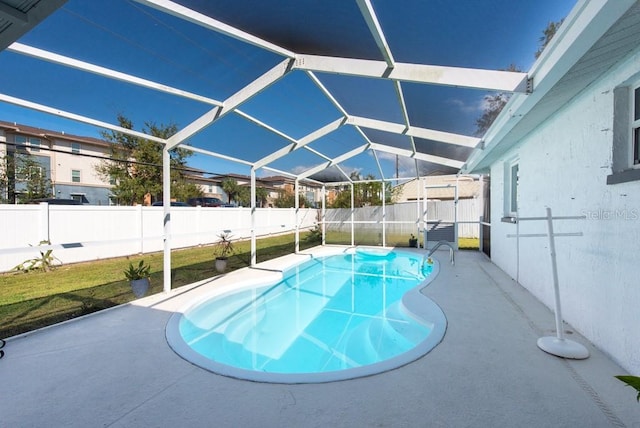 view of swimming pool featuring a patio area and glass enclosure