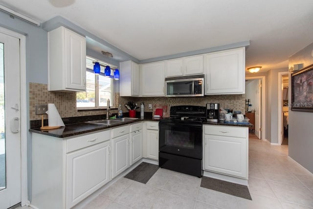 kitchen featuring sink, tasteful backsplash, electric range, and white cabinets