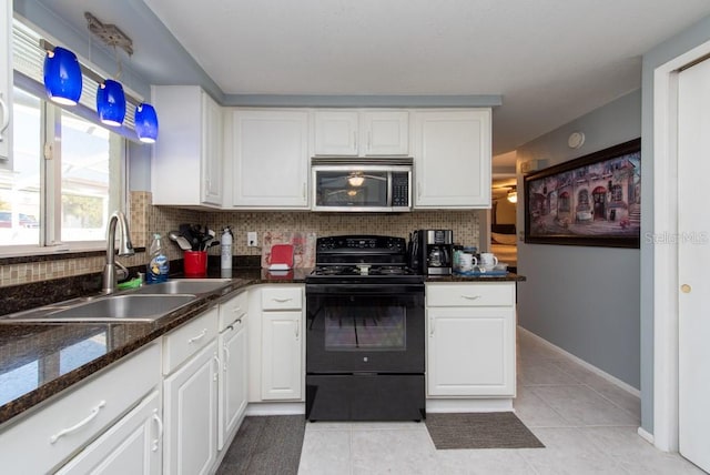 kitchen with decorative backsplash, light tile patterned floors, white cabinetry, black range with electric cooktop, and sink