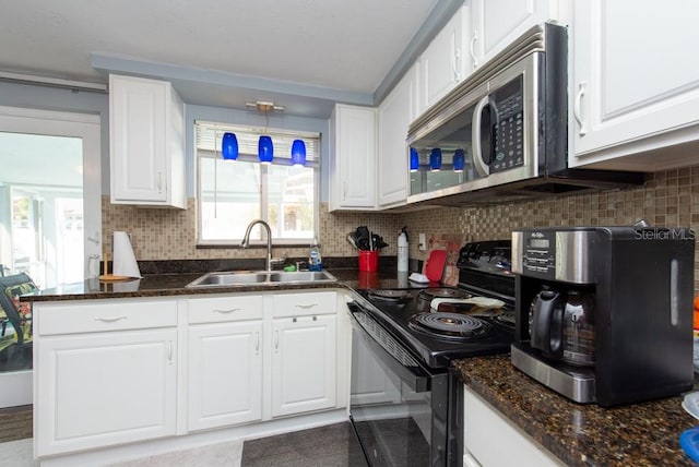 kitchen featuring white cabinets, sink, and black electric range