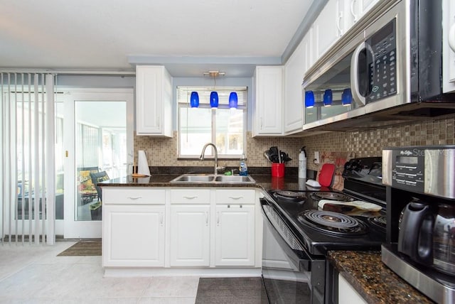 kitchen with sink, appliances with stainless steel finishes, and white cabinetry