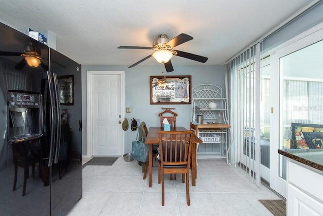 tiled dining space with ceiling fan