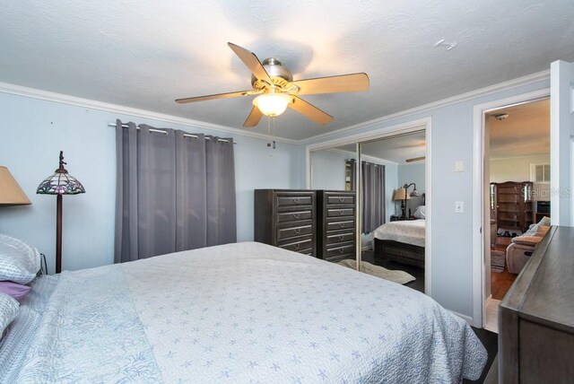 bedroom featuring a closet, ceiling fan, and ornamental molding