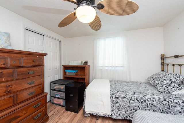 bedroom featuring a closet, light hardwood / wood-style floors, and ceiling fan