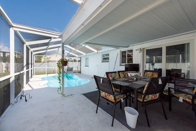 view of patio featuring a fenced in pool and glass enclosure