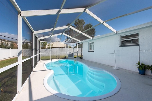 view of pool with a patio area and a lanai