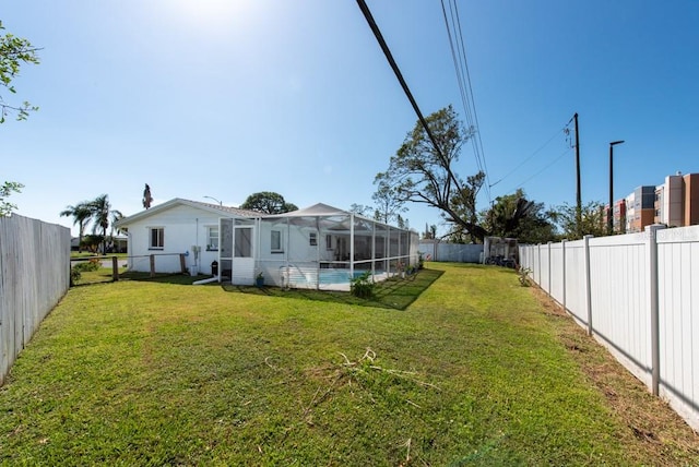 view of yard with a fenced in pool and a lanai