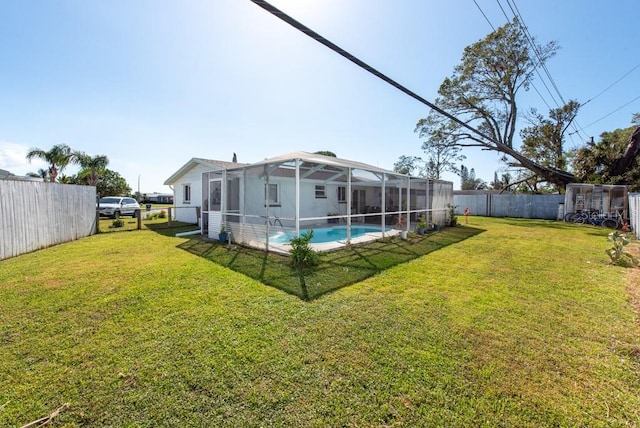 view of yard featuring a fenced in pool and a lanai