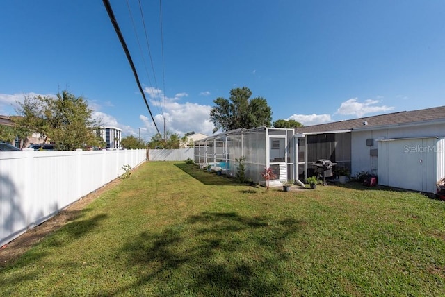 view of yard featuring glass enclosure