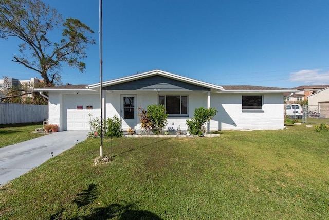 ranch-style home featuring a front lawn and a garage