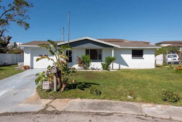 ranch-style house featuring a front lawn and a garage