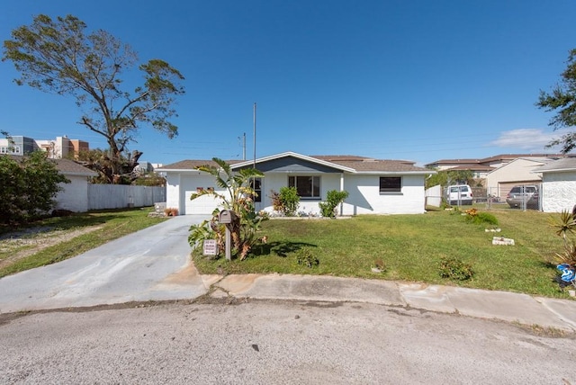 single story home with a garage and a front lawn