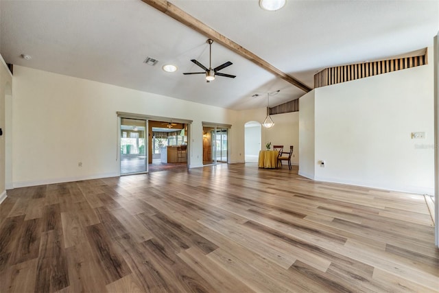 unfurnished living room featuring beam ceiling, high vaulted ceiling, light wood-type flooring, and ceiling fan