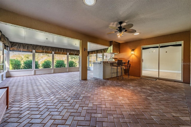 view of patio / terrace featuring exterior bar and ceiling fan