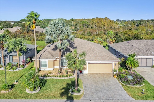 view of front of house featuring a garage and a front lawn