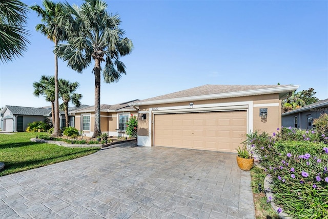 single story home featuring a front yard and a garage