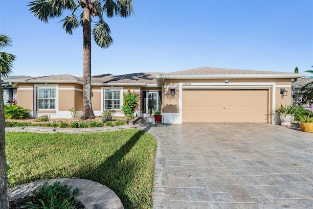 view of front of house featuring a front yard and a garage