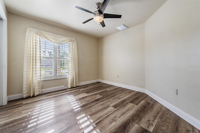 unfurnished room featuring ceiling fan, wood-type flooring, and a textured ceiling