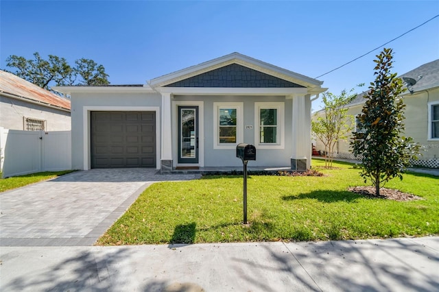 view of front of property with a front yard and a garage