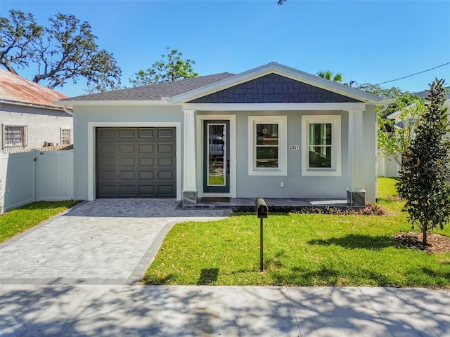 view of front facade with a front yard and a garage