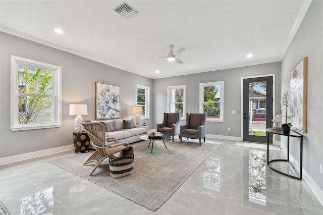 living room featuring a wealth of natural light, crown molding, and ceiling fan