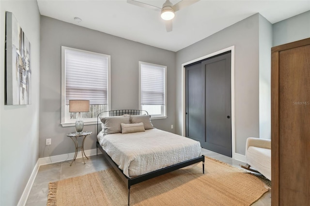 bedroom featuring ceiling fan, a closet, and tile patterned flooring