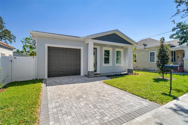 ranch-style house featuring a garage and a front lawn