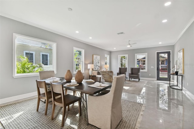 dining space with ceiling fan and crown molding